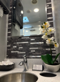 Secondary interior view showing sinks, mirrors and stall doors