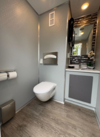 Interior of ADA + 2 Stall restroom trailer with vanity and fixtures — Royal Restrooms of California