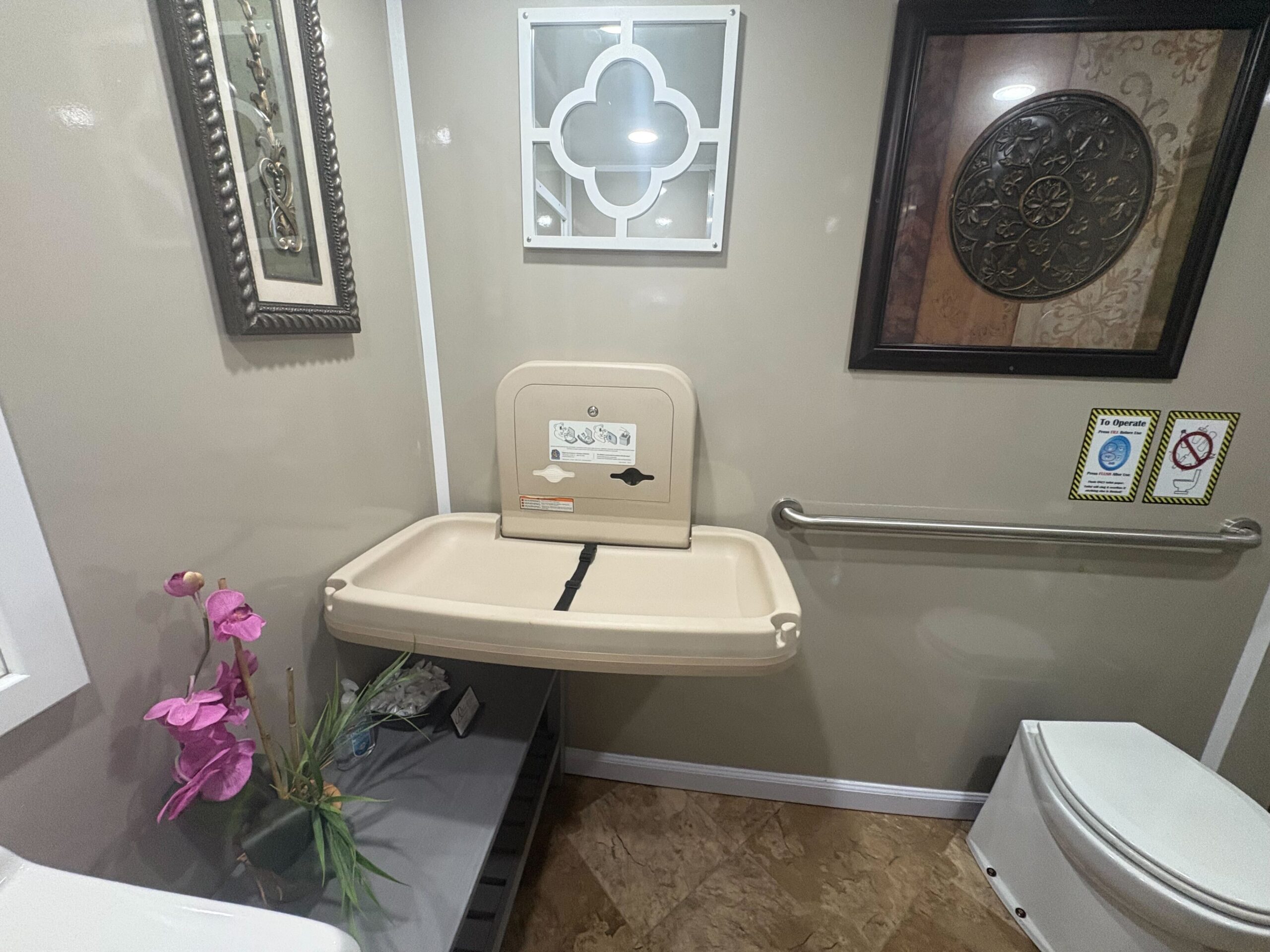 ADA restroom interior with grab bars and turning radius